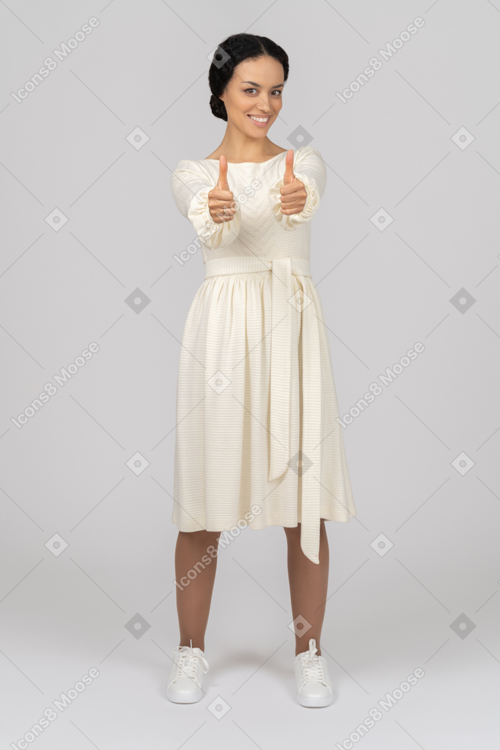 Cheerful young woman showing thumbs up