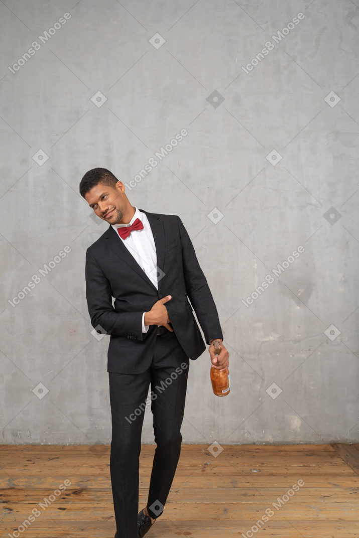 Tipsy man staggering with a bottle of champagne in his hand