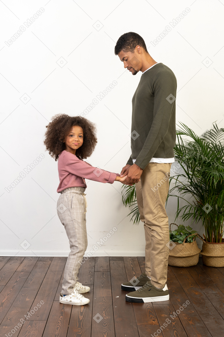 Father and daughter hold hands