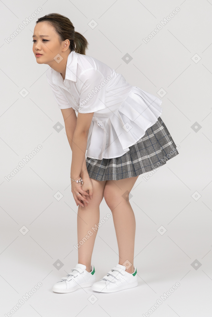 A young asian woman feeling pain in knee