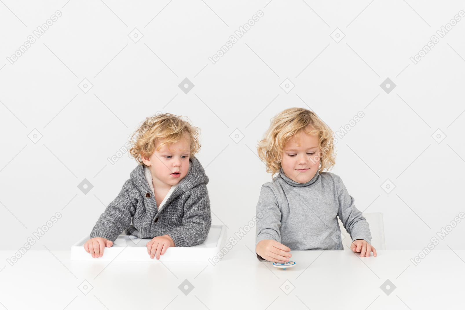 Boy playing with spinning top next to his brother
