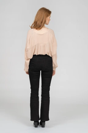 Back view of young woman looking aside