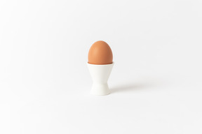 Brown egg served in a white egg cup