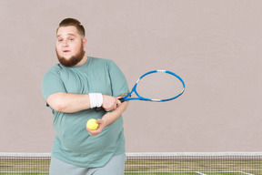 A man holding a tennis racquet on a tennis court