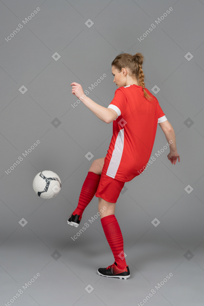 A young woman juggling a ball