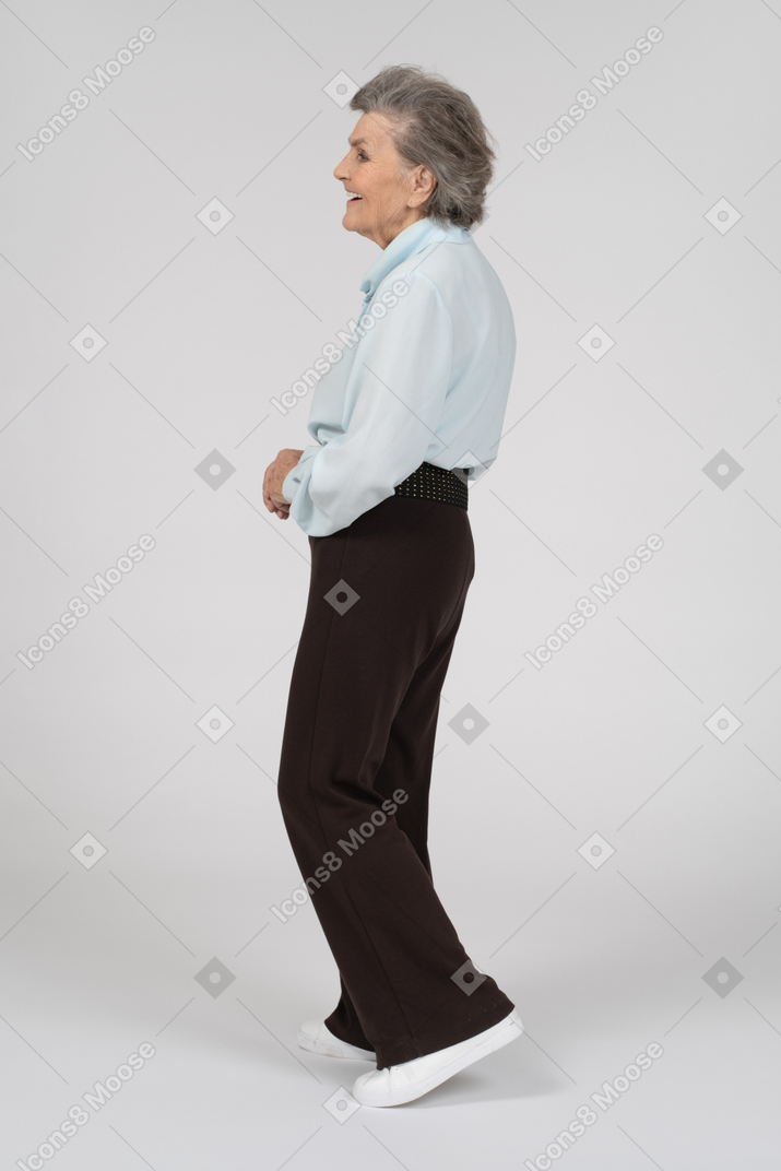 Side view of an old woman walking