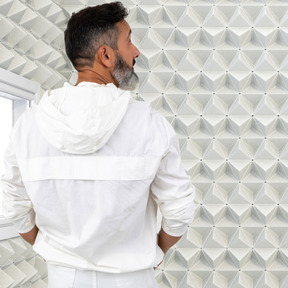 A man standing in a white soundproof room