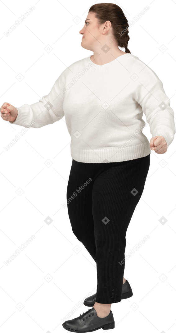 Plump woman in casual clothes dancing