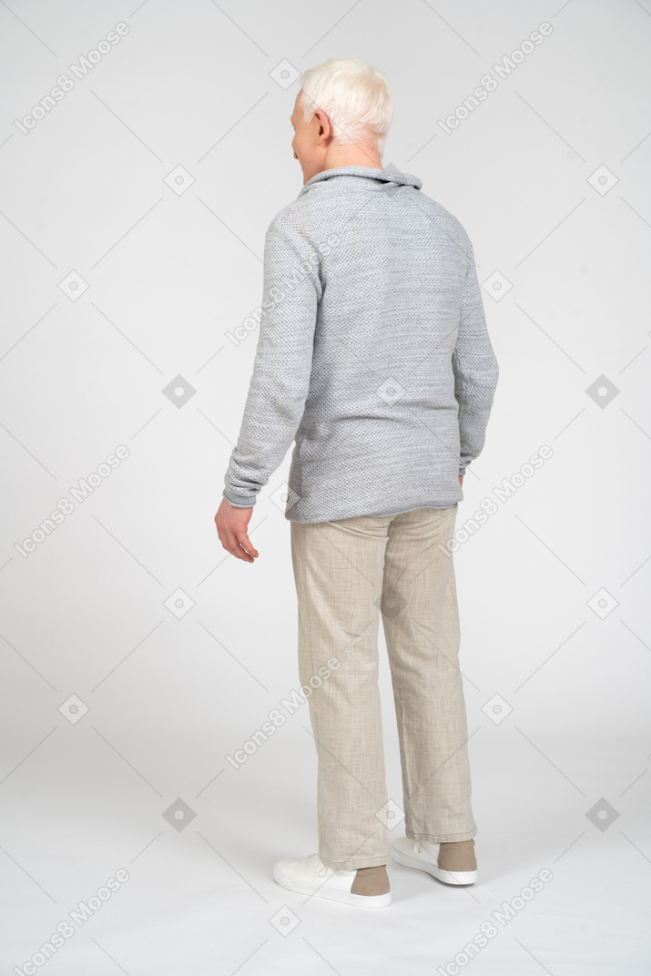 Back view of a blonde man standing
