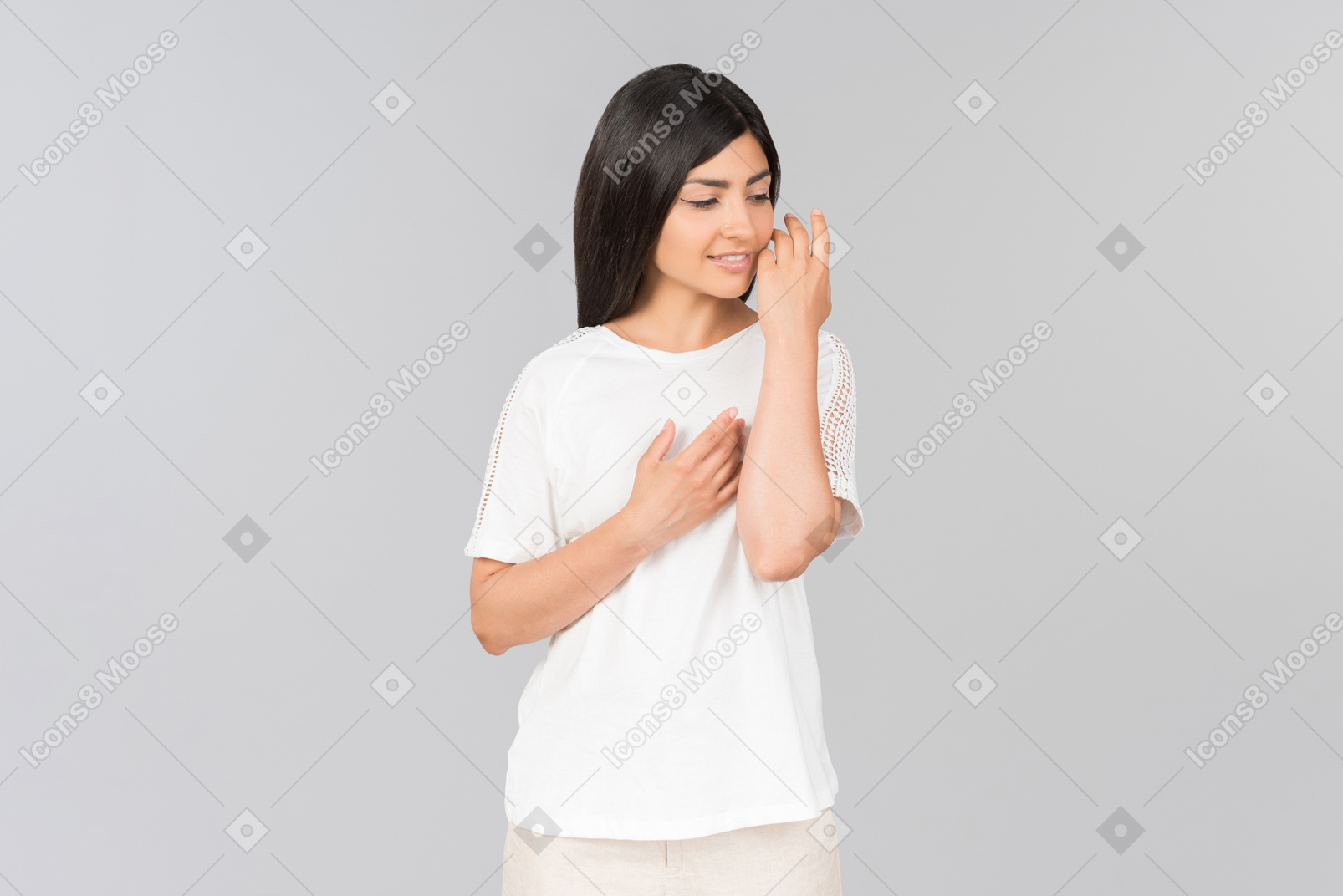 Dreamy indian girl touching her face with a hand