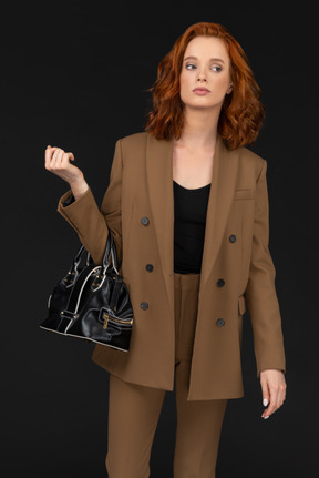 Confident young woman in a brown suit