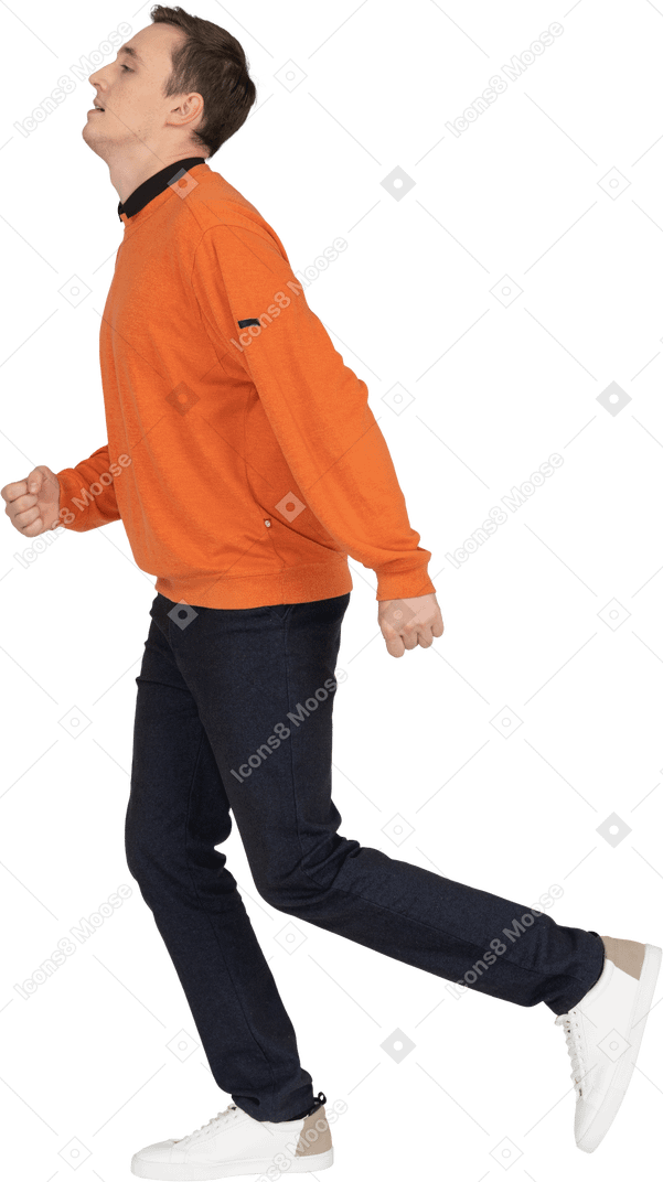 Young man in orange sweatshirt walking