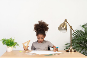 Good looking cute girl with books at the table