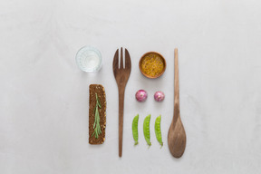 Snack, verre d'eau, épices et couverts en bois