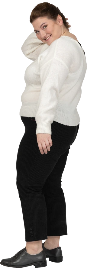 Happy plump woman standing in profile