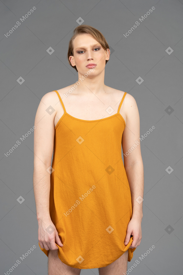 Genderqueer person standing with arms at sides