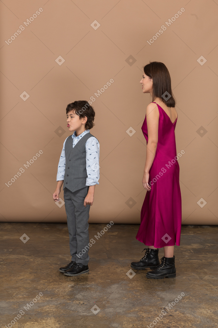 Young woman and little boy standing in profile
