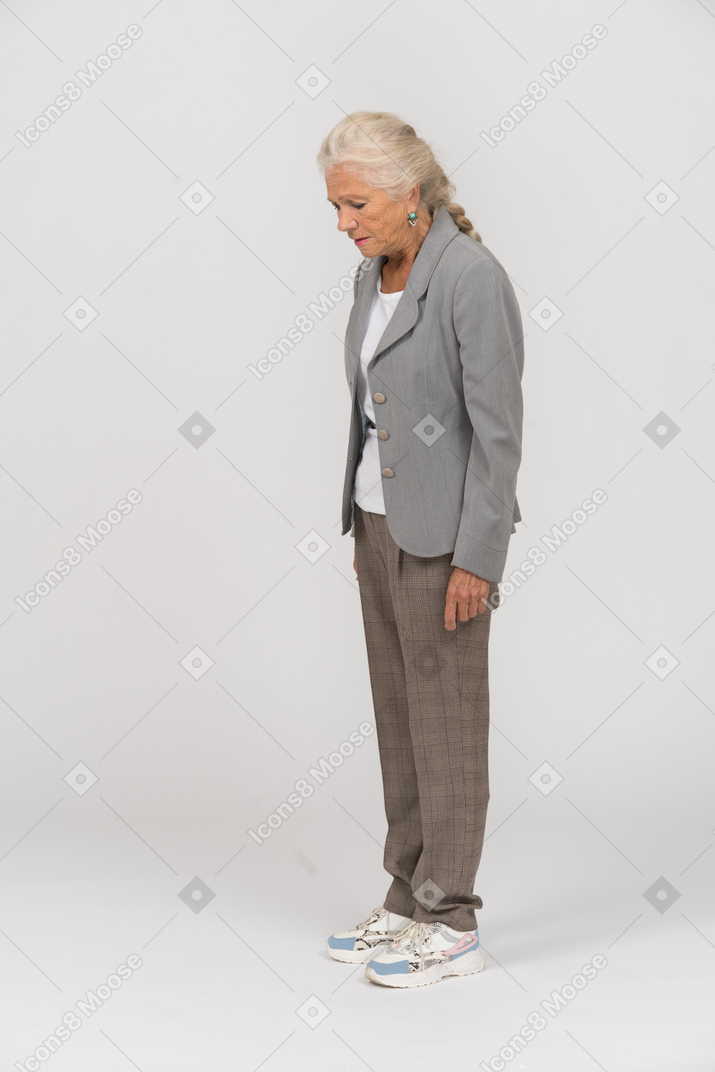 Side view of an old lady in suit looking down