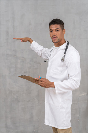 Doctor holding a clipboard and gesturing