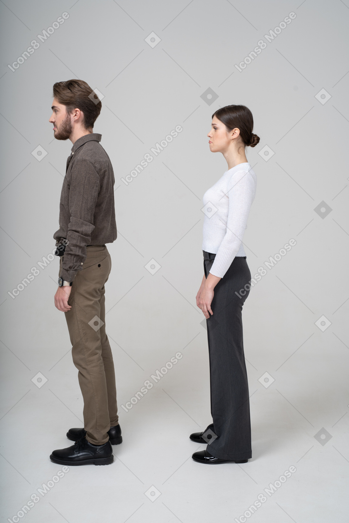 Side view of a cute pouting couple in office clothing