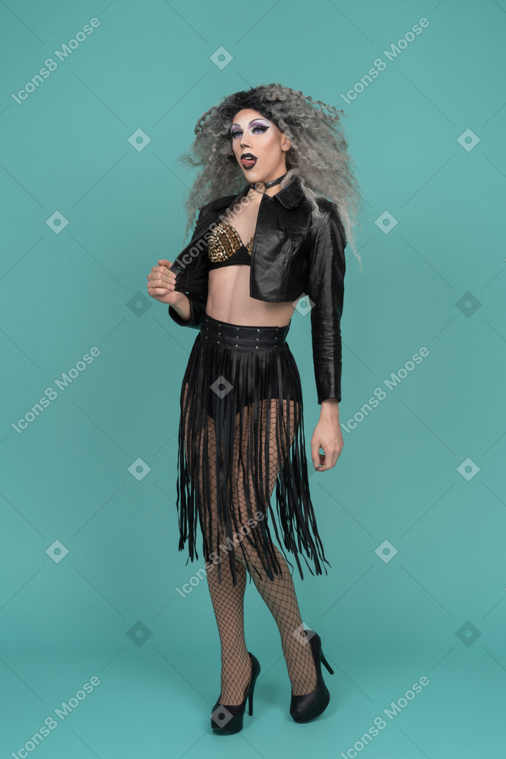 Drag queen in leather jacket licking their lips