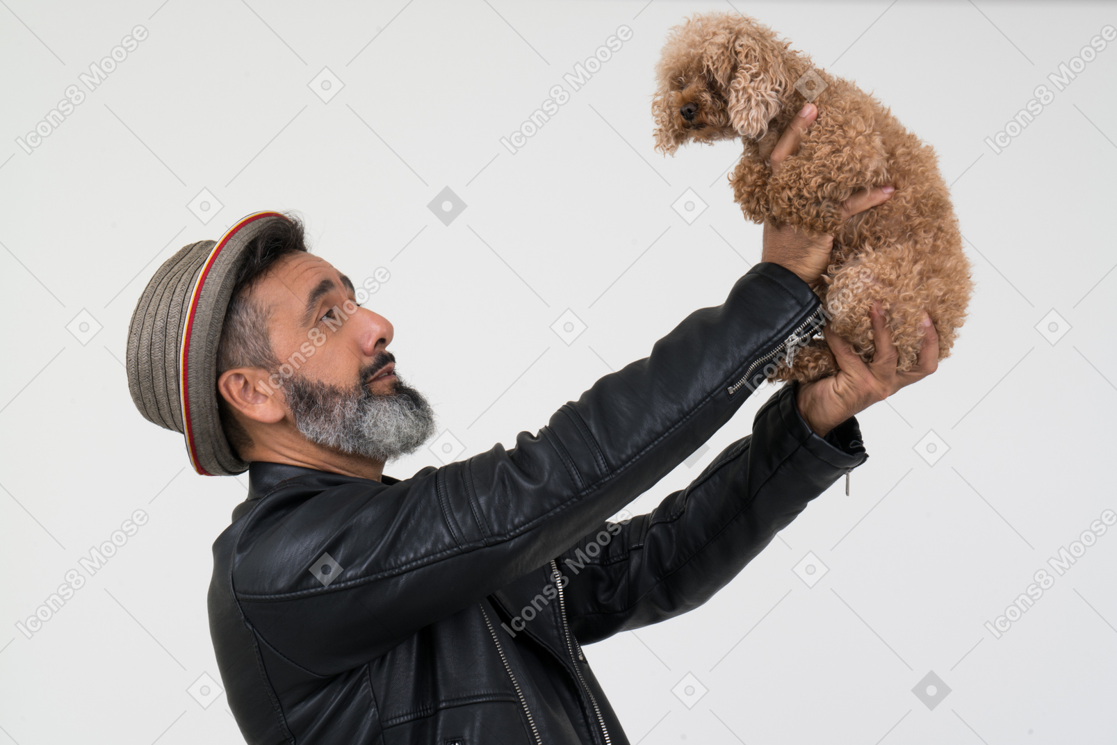 Mature man looking lovingly at his puppy