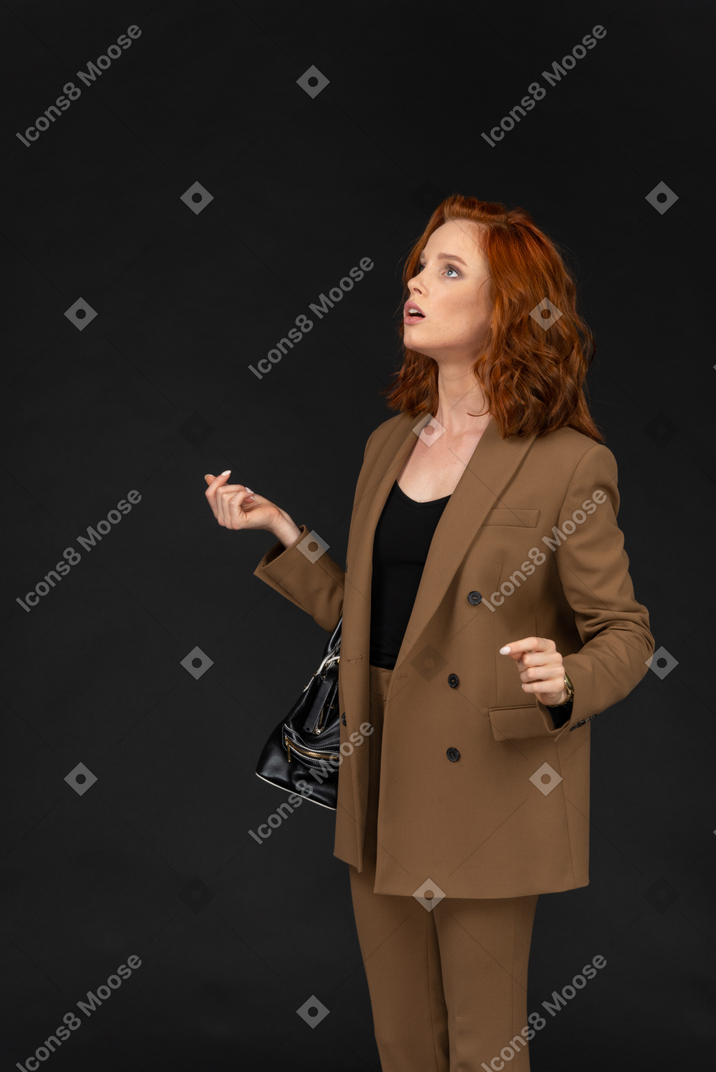 Surprised businesswoman looking up