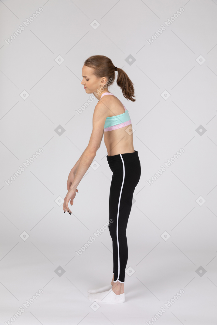 Side view of a weak teen girl in sportswear leaning forward