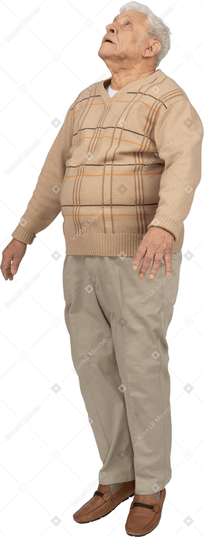 Front view of an old man in casual clothes jumping