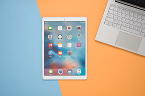 Laptop and digital tablet over contrast background