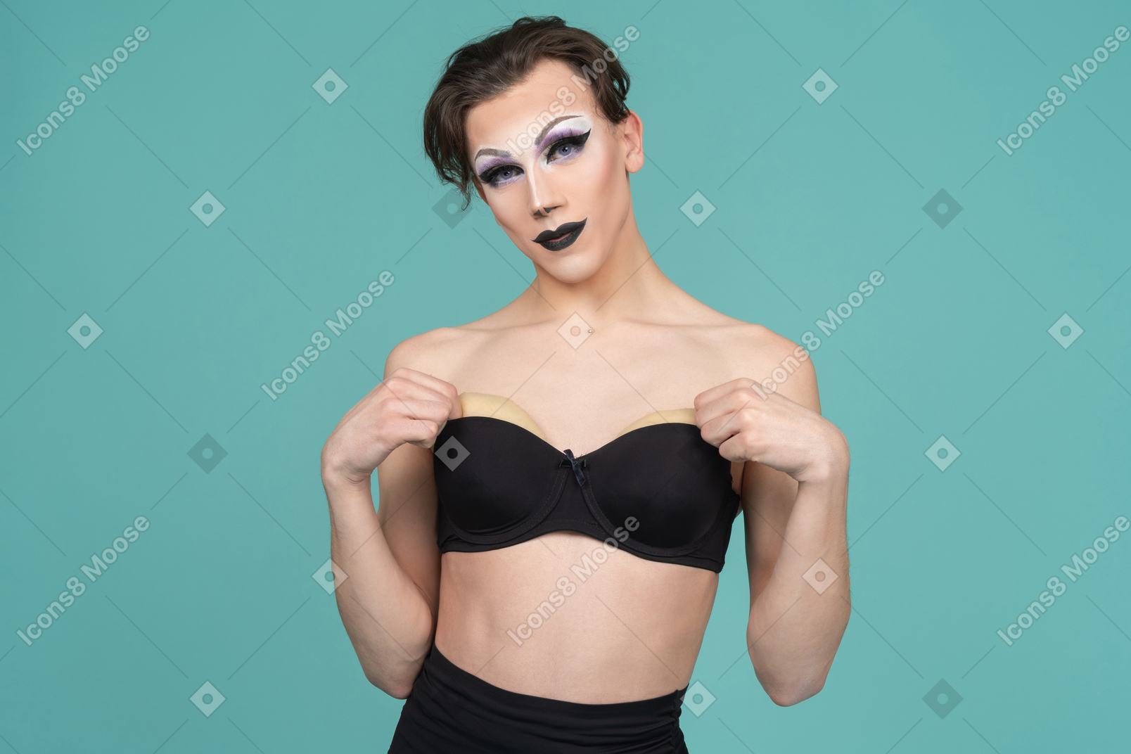 Drag queen taking padding out of bra