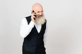 Aged man smiling and talking on the phone