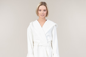 Pretty young woman in white bathrobe