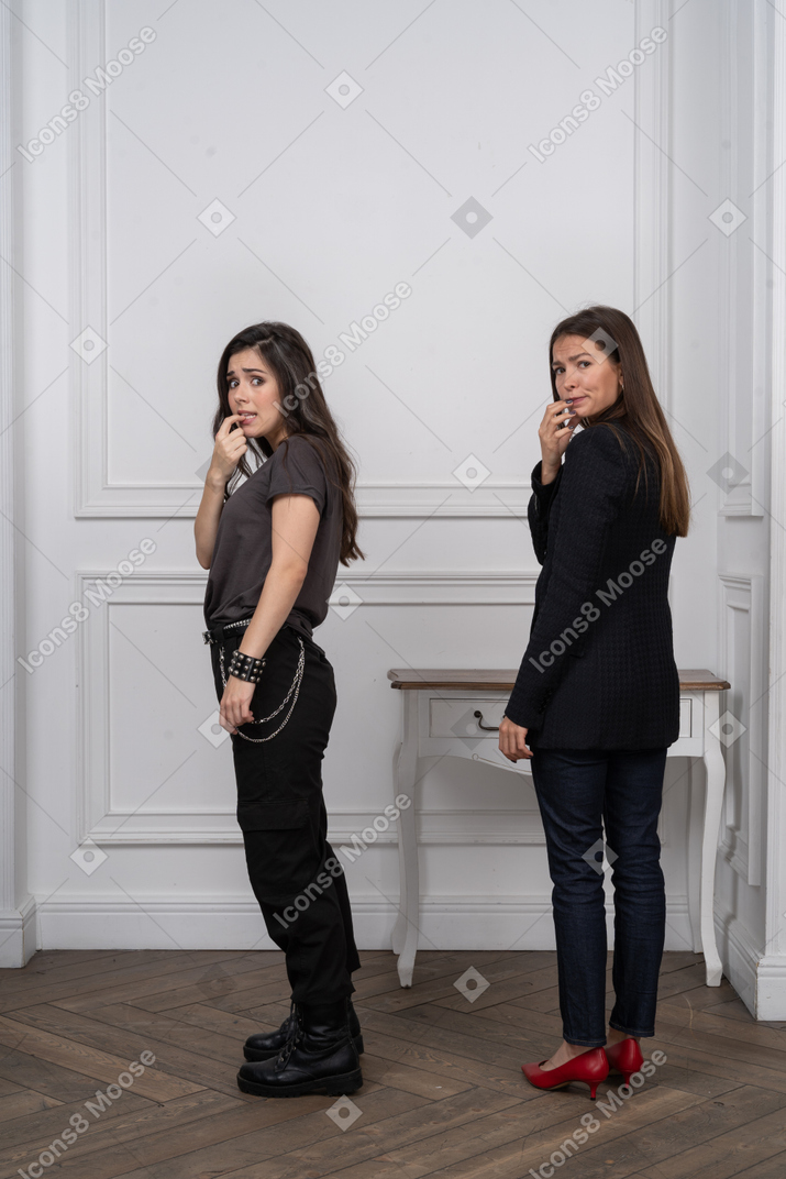 Two women looking guilty