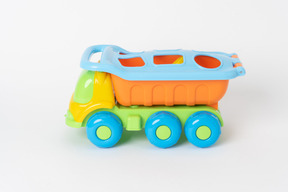 A colorful toy dump truck standing against a plain white background