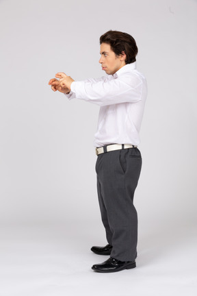 Side view of a man holding up crossed fingers
