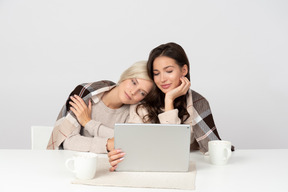 Young women embracing and watching movies