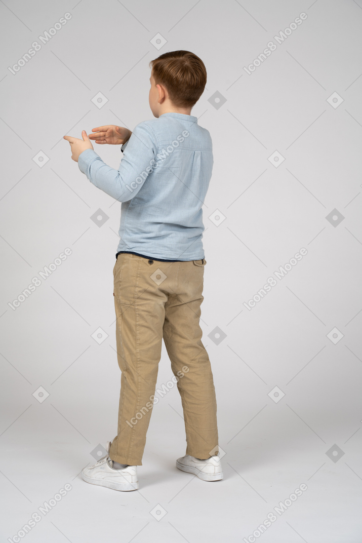 Boy standing with back to the camera