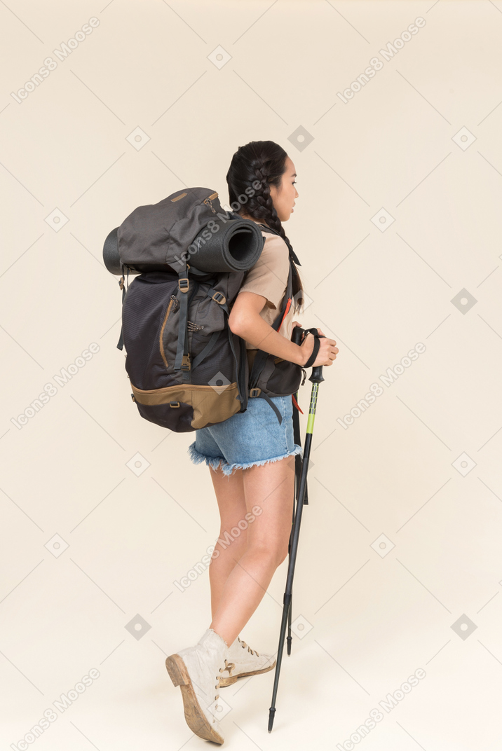 Hiker woman walking using trekking poles
