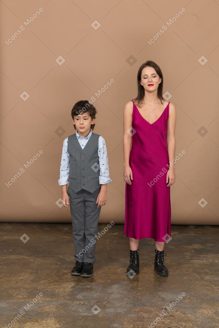 Woman with closed eyes standing with boy