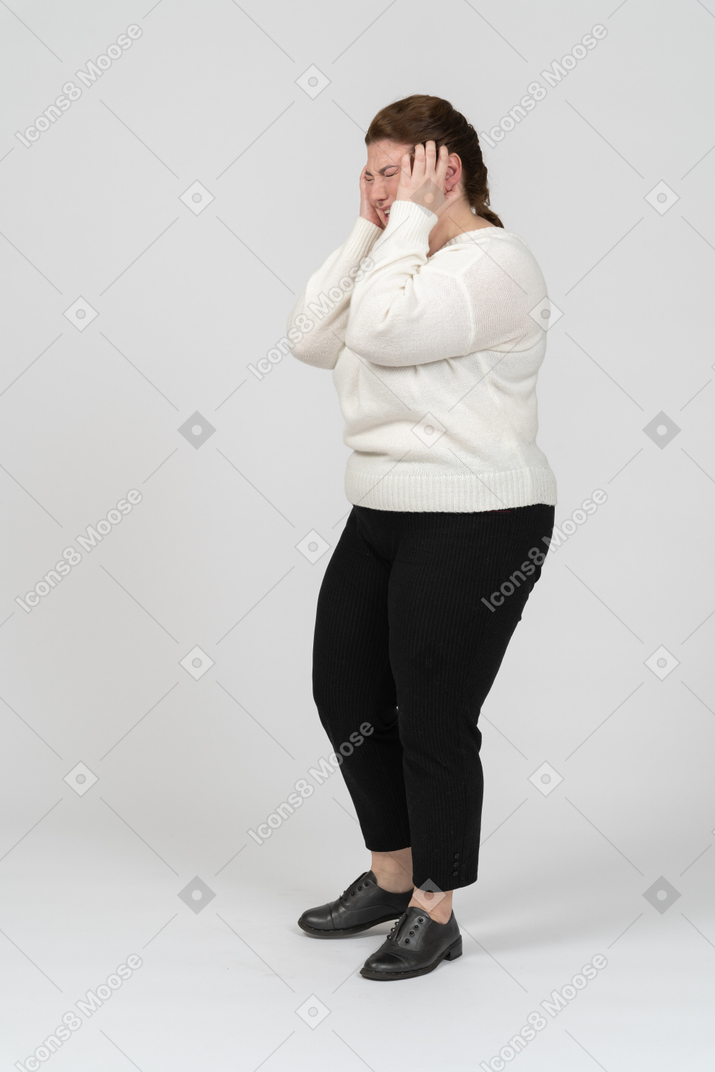 Plump size woman in casual clothes touching head