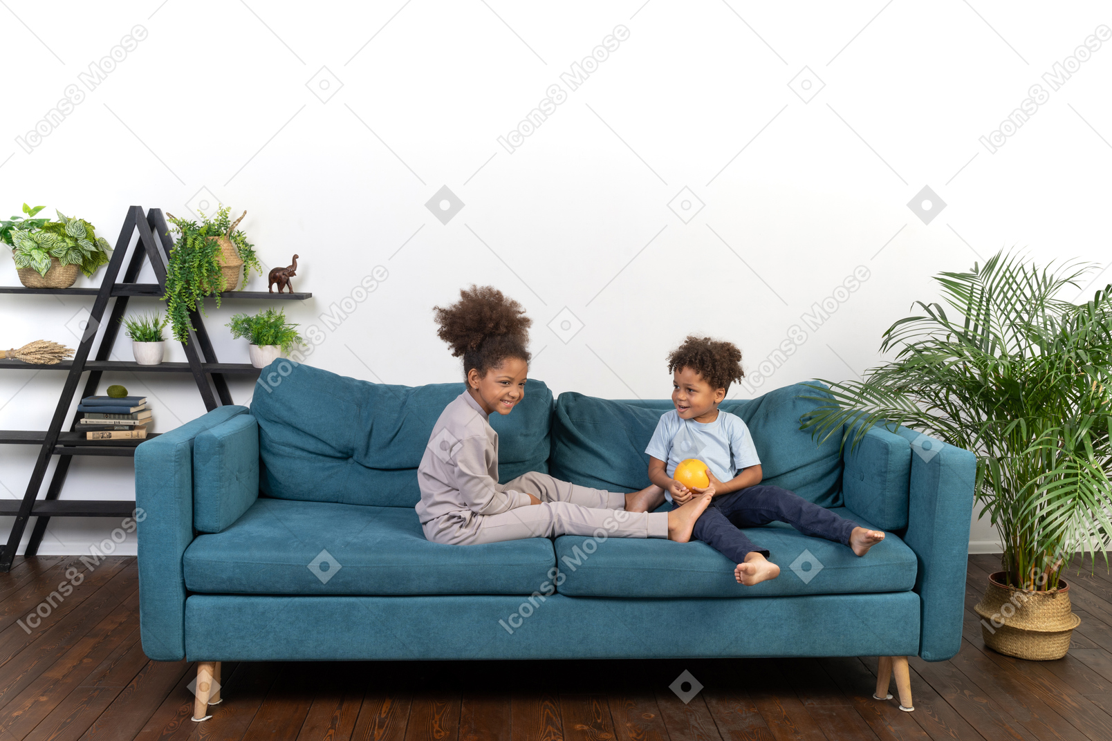 Good looking boy and girl play on the sofa