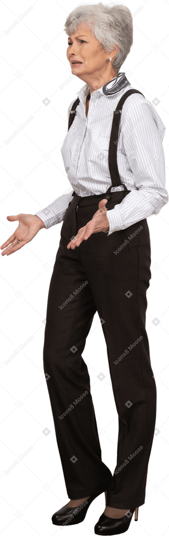 Side view of a worried old lady in office clothing holding hands together