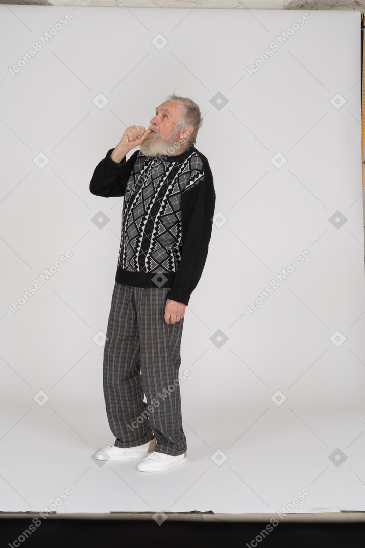 Old man covering mouth with fist
