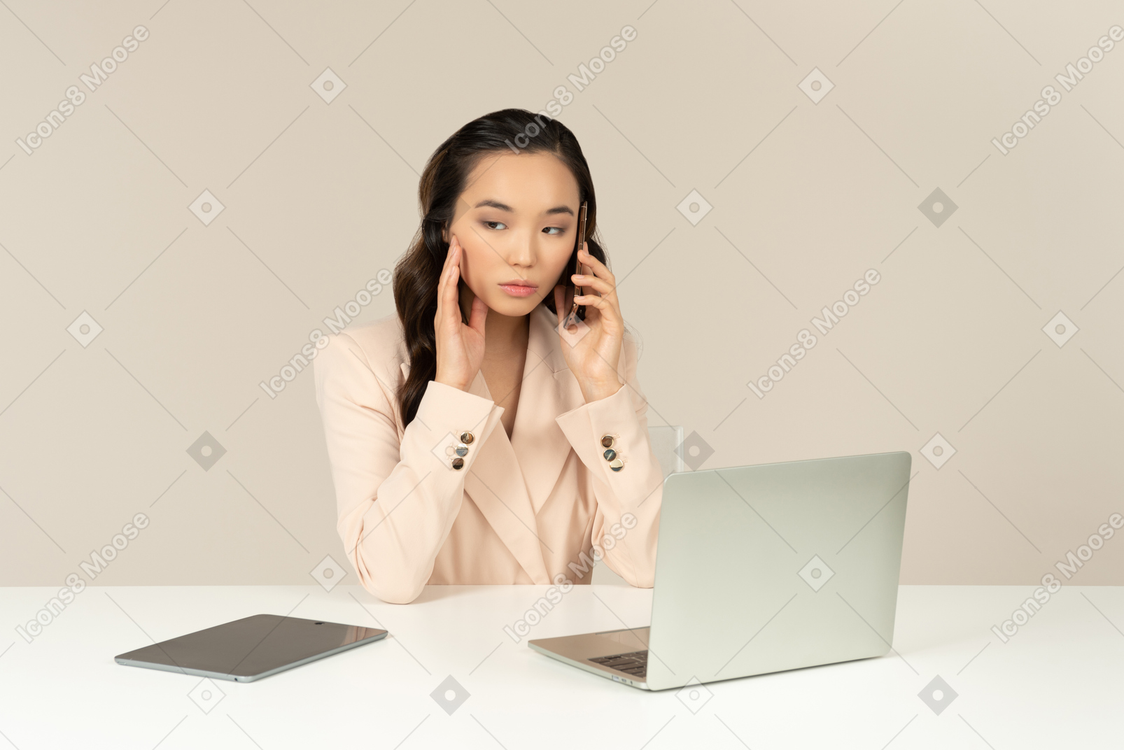 Asian female office employee looking bothered with phone call