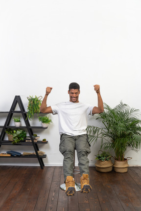 Good looking young man sitting on a chair