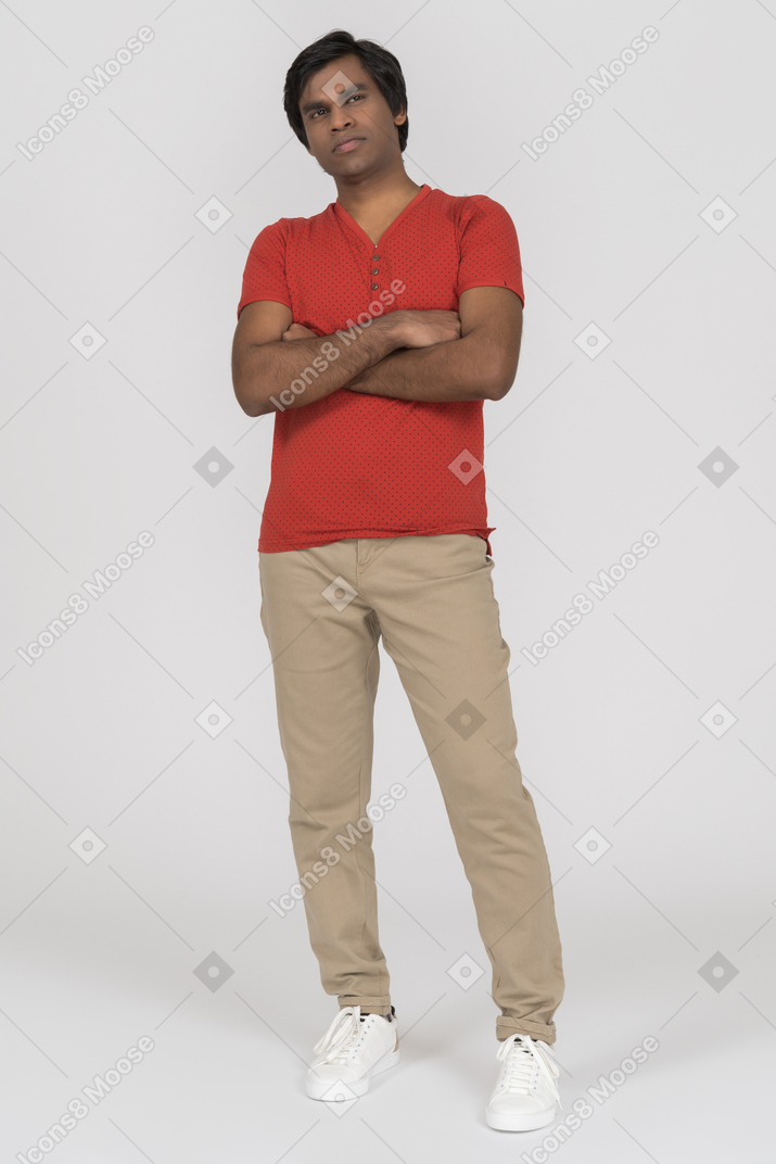 Young man standing with crossed arms