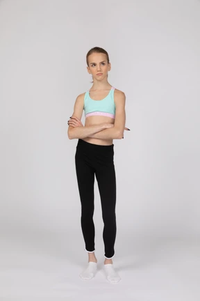 Side view of a teen girl in sportswear raising hand and arguing