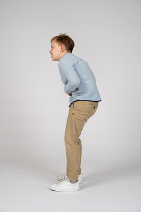 Side view of a boy suffering from stomachache