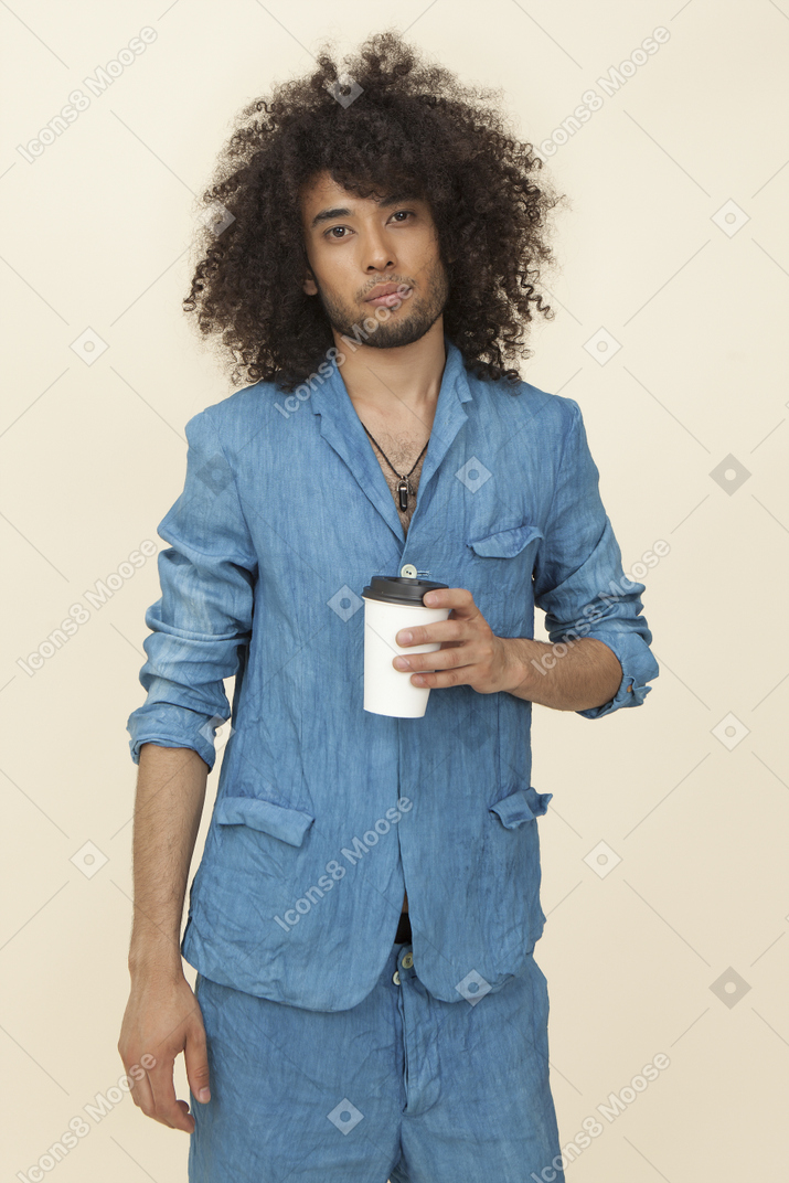 Afroman in denim suit holding cup of coffee